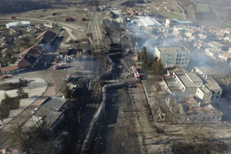 In this aerial view emergency services attend the scene of devastation after a tanker train derailed and a gas tank exploded in the village of Hitrino, northeastern Bulgaria, early Saturday, Dec. 10, 2016.