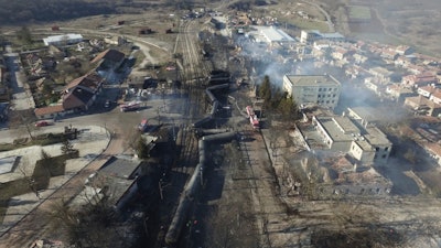 In this aerial view emergency services attend the scene of devastation after a tanker train derailed and a gas tank exploded in the village of Hitrino, northeastern Bulgaria, early Saturday, Dec. 10, 2016.