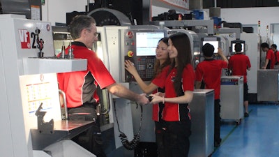 Gordon Styles (left) working with two Star Prototype employees on a Haas VF-2SS CNC.
