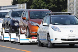 Nissan Motor Co.'S 'Leaf', with no one inside, pulls a trailer with three other Leafs on it, during a demonstration of the automaker's Intelligent Vehicle Towing system at Nissan Oppama plant in Yokohama, near Tokyo Monday, Dec. 5, 2016. Nissan Motor Co. is testing out self-driving cars at one of its plants in Japan to tow vehicles on a trailer to the wharf for loading without anyone behind the steering wheel.