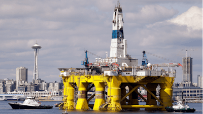 In this May 14, 2015, file photo, the oil drilling rig Polar Pioneer is towed toward a dock in Elliott Bay in Seattle. The rig was the first of two drilling rigs Royal Dutch Shell was outfitting for Arctic oil exploration.