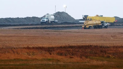 This Oct. 11, 2013 file photo shows cleanup at the site of a Tesoro Corp. pipeline break that spilled more than 20,000 barrels of oil into a Tioga, N.D., wheat field. The massive oil spill still isn't fully cleaned up three years and three months after it happened. The company responsible hasn't even set a date for completion. Some say that one of the largest onshore oil spills recorded in the U.S. serves as a cautionary example, especially given a recent pipeline break about 150 miles south and ongoing debates over the four-state Dakota Access pipeline.