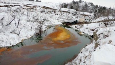 This Dec. 10, 2016 photo provided by the North Dakota Department of Health shows an oil spill from the Belle Fourche Pipeline that was discovered Dec. 5 in Ash Coulee Creek, a tributary of the Little Missouri River, near Belfield, N.D. The discovery of the pipeline spill in western North Dakota has drawn heightened attention because of the battle over the Dakota Access oil pipeline being built across the state.