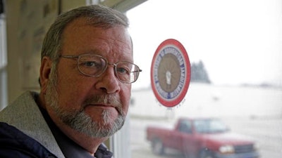 Bill Davis, of Gas City, Ind., poses in his union's meeting hall in Huntington, Ind., Tuesday, Dec. 6, 2016. Davis works at the United Technologies Electronic Controls factory in Huntington where workers are working mostly seven days a week since late October, making control panels for the furnace, air conditioning and refrigeration industries. Leaders of their union believe the company is doing so ahead of the factory's layoffs expected to start in April and continue into 2018.