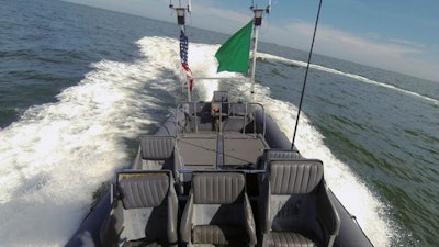 An unmanned rigid-hull inflatable boat operates autonomously during an ONR-sponsored demo of swarmboat technology.
