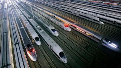 In this Wednesday, Jan. 11, 2012 file photo, China's CRH high-speed trains sit on tracks at a maintenance base in Wuhan, in central China's Hubei province. The Chinese government is planning to expand the country's high-speed rail network to 30,000 kilometers (18,600 miles) by 2020, part of public infrastructure spending aimed at shoring up economic growth.