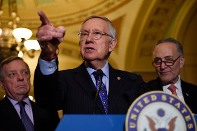 Senate Minority Leader Harry Reid of Nev., flanked by Senate Minority Whip Richard Durbin of Ill., left, and Senate Minority Leader-elect Charles Schumer of N.Y., answers questions from the media after the Democratic policy luncheon on Capitol Hill in Washington, Tuesday, Dec. 6, 2016.