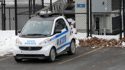 In this Feb. 12, 2015 file photo, A New York City Police Department Smart car is parked in the parking lot of Central Park's precinct in New York. The NYPD plans to replace its three-wheeled scooters with Smart cars. NYPD has announced plans to expand its fleet of Smart cars, Thursday, Dec. 1, 2016, to replace the three-wheeled scooters that officers utilized for decades.