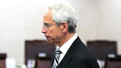 Donald Rosenberg, executive vice president, general counsel and corporate secretary of Qualcomm Inc., enters the Fair Trade Com mission's sentence room at the government complex in Sejong, South Korea, Wednesday, Dec. 28, 2016. South Korea's antitrust regulator slapped a 1.03 trillion won ($865 million) fine on Qualcomm Inc. Wednesday for allegedly violating competition laws.