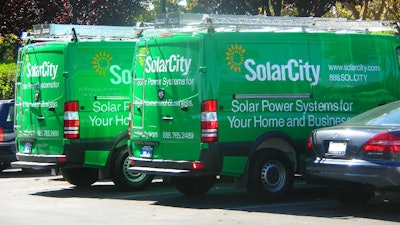 In this October 2009 photo, a pair of SolarCity Dodge Sprinters are parked outside the SolarCity headquarters in Foster City, California.