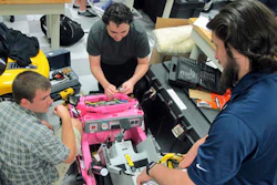 In this Thursday, Dec. 1, 2016, photo, University of North Florida students, Garrett Baumann, right, Chris Martin, center, and Jason Pavichall, work to customize a toy car so that it can be used by a girl with cerebral palsy at the university in Jacksonville, Fla. At the university, engineering and physical therapy students are converting drivable toy cars from store shelves into custom-made fun for disabled children. The Adaptive Toy program is now in its third year, has received a 5-year grant from the National Institutes of Health and is helping families with disabled children while giving the students a dose of community service that will stick with them long after graduation.
