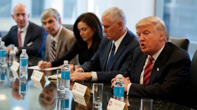 President-elect Donald Trump speaks during a meeting with technology industry leaders at Trump Tower in New York, Wednesday, Dec. 14, 2016. From left are, Amazon founder Jeff Bezos, Alphabet CEO Larry Page, Facebook COO Sheryl Sandberg, Vice President-elect Mike Pence, and Trump.
