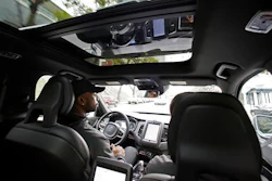 In this Tuesday, Dec. 13, 2016, file photo, Devin Greene sits in the front seat of an Uber driverless car during a test drive in San Francisco.