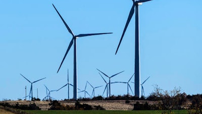 This photo provided by Google shows windmills at a wind farm in Minco, Okla., that provides Google with some of its renewable energy. Google says it believes that beginning in 2017, it will have amassed enough renewable energy to meet all of its electricity needs throughout the world.