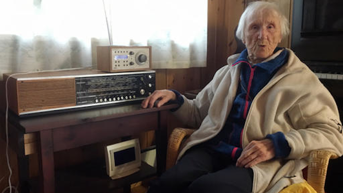 In this photo taken on Sunday, Jan. 8, 2017, 98-year-old Judith Haaland sits next to her decades-old radio set in Stavanger, Norway. In a move likely to be watched closely by other nations, the Norwegian government will begin shutting off the FM signal on Wednesday, Jan. 11, 2017. By the end of the year, national networks will be available only on Digital Audio Broadcast, or DAB.
