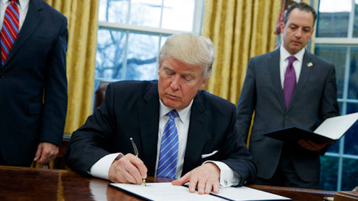 In this Monday, Jan. 23, 2017, file photo, President Donald Trump signs an executive order to withdraw the U.S. from the 12-nation Trans-Pacific Partnership trade pact agreed to under the Obama administration in the Oval Office of the White House in Washington. With his rejection of an Asian trade pact, Trump has started tackling policy changes that could inadvertently give China room to assert itself as a regional leader and worsen strains over the South China Sea and Taiwan.