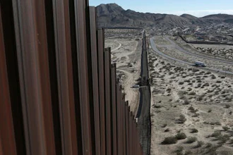 In this Jan. 25, 2017 photo, a truck drives near the Mexico-US border fence, on the Mexican side, separating the towns of Anapra, Mexico and Sunland Park, New Mexico.