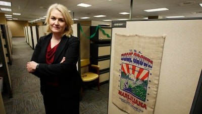 In this photo taken, Thursday, Jan. 19, 2017, Lori Ajax, chief of California's Bureau of Medical Cannabis Regulation, poses in the bureau's office in Sacramento, Calif. Ajax, and her staff are crafting regulations and rules that will govern the state's emerging legal pot mark, from where and how plants can be grown to setting guidelines to track the buds from fields to storefront.