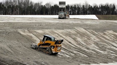 In this Jan. 25, 2017 photo, heavy equipment is used at an ash storage site at Gallatin Fossil Plant in Gallatin, Tenn. Environmental groups are taking the Tennessee Valley Authority, the nation's largest public utility, to trial over whether waste from the coal-fired power plant near Nashville polluted the Cumberland River. A trial opens Monday, Jan. 30, in federal court in Nashville as the groups claim coal ash waste illegally seeped into the Cumberland River.