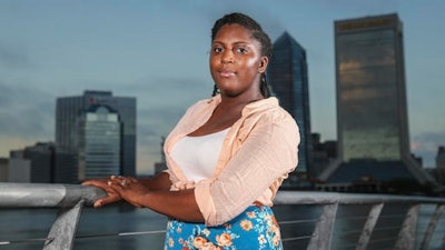 Asia Howard poses for a photo at St. Johns River Park at sunrise, in Jacksonville, Fla. Howard was stuck in mostly retail and fast-food jobs after graduating high school, unable to get a job in banking, a profession she prized for its steady hours. After further developing her career and computer skills, she landed a job in mortgage lending that paid nearly double what she earned in previous jobs.