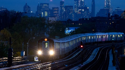 In this file photo, a No. 7 subway train rides the rails in the Queens borough of New York, with the Manhattan skyline in the background.