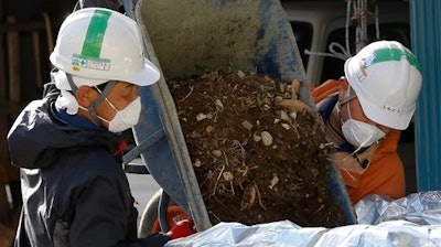 Decommissioning workers clean up the site at Fukushima.