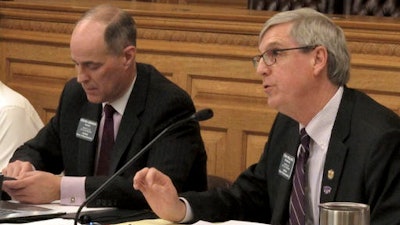Kansas state Rep. Tom Phillips, right, R-Manhattan, asks a question during a House Taxation Committee hearing on a bill to repeal an income tax break for more than 330,000 farmers and business owners, Thursday, Jan. 19, 2017, at the Statehouse in Topeka, Kan. To his left is the committee's chairman, Rep. Steven Johnson, R-Assaria, who supports repealing the tax break, as Phillips does.