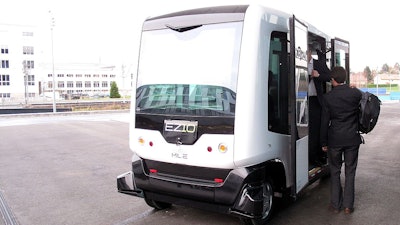 The Ligier EZ-10 autonomous electric mini-shuttle is demonstrated in front of the EPFL Conference Center in Switzerland.