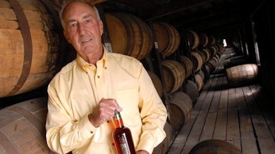In this Sept. 20, 2006, file photo, Heaven Hill's master distiller Parker Beam holds a bottle of Rittenhouse Rye Whisky made at the Bardstown, Ky. distillery. Beam, who carried on his family's historic bourbon-making tradition, died Monday, Jan. 9, 2017, after battling amyotrophic lateral sclerosis, better known as Lou Gehrig's disease. He was 75.