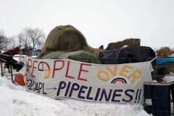 Hay is stacked up to feed horses at a protest encampment along the route of the Dakota Access oil pipeline near Cannon Ball in southern North Dakota on Tuesday, Jan. 24, 2017. President Donald Trump on Tuesday issued an executive action to advance construction of the pipeline, which opponents believe threatens drinking water and cultural sites. The pipeline developer disputes that.