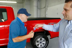 FILE - In this Thursday, Nov. 19, 2015, file photo, Alton John, left, from Kittanning, Pa., gets the keys to his new 2015 Ford F-150 Supercab 4x4 pickup truck from salesman Robert Myers as he takes delivery at Butler County Ford in Butler, Pa. U.S. car shoppers will find plentiful deals, relatively low interest rates and lots of high-tech choices in the market in 2017.