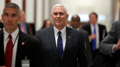 Vice President-elect Mike Pence walks through the halls of Russell Senate Office Building on Capitol Hill in Washington, Tuesday, Jan. 17, 2017.