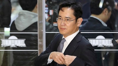 In this Tuesday, Dec, 6, 2016, file photo, Lee Jae-yong, a vice chairman of Samsung Electronics Co., arrives for a hearing at the National Assembly in Seoul, South Korea. South Korean authorities say a Samsung scion will be questioned as a suspect in a bribery case in the massive influence-peddling scandal that led to the president's impeachment.