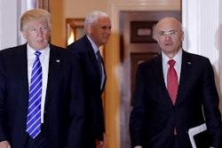 In this Nov. 19, 2016 file photo, President-elect Donald Trump walks Labor Secretary-designate Andy Puzder from Trump National Golf Club Bedminster clubhouse in Bedminster, N.J. Puzder was CEO of a fast food empire that is outsourcing jobs on his watch, a stark contrast with his boss' threats and tweeted slaps at companies that outsource jobs.