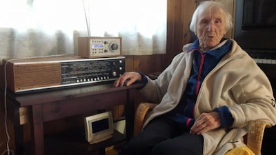 In this photo taken on Sunday, Jan. 8, 2017, 98-year-old Judith Haaland sits next to her decades-old radio set in Stavanger, Norway. In a move likely to be watched closely by other nations, the Norwegian government will begin shutting off the FM signal on Wednesday, Jan. 11, 2017. By the end of the year, national networks will be available only on Digital Audio Broadcast, or DAB.
