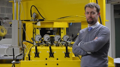 Dr. Andrew Bunger in his Benedum Hall lab with the newly installed compression frame he uses to simulate the high-stress environment deep inside the Earth.