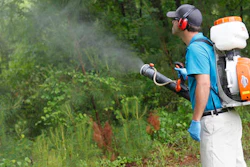 In this Friday, May 16, 2014, file photo, Daniel Lewis, Mosquito Authority, sprays to kill mosquitos before the summer season.