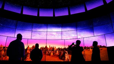 In this Thursday, Jan. 7, 2016, file photo, people look at an LG OLED 4K TV display at the LG booth during CES International, in Las Vegas. Flashy new television sets with buzzwords such as 4K, quantum dot and OLED are appearing at the annual CES gadget show in Las Vegas during the first week of 2017. Expect bigger sizes and brighter, more colorful pictures. This year is mostly about improving whatâs already out there.