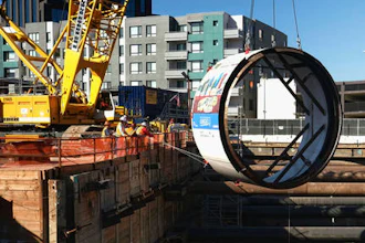 In this Oct. 19, 2016, file photo, workers lower the tail shield section of a tunnel boring machine into a 45 foot deep pit, during a ceremonial naming and lowering for the Regional Connector Transit Project downtown Los Angeles. Just weeks after suddenly tweeting 'Traffic is driving me nuts' and 'am going to build a tunnel boring machine and just start digging,' Elon Musk, the SpaceX and Tesla founder says it's on the verge of happening. 'Exciting progress on the tunnel front,' he tweeted Wednesday, Jan. 25, 2017. 'Plan to start digging in a month or so.'