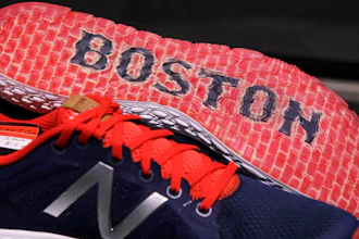 In this Wednesday, Dec. 28, 2016 photograph, the word 'Boston' accents the sole of the New Balance Zante v2 shoe on display at the storefront of the world headquarters of New Balance in the Brighton neighborhood of Boston. Some of America's top sneaker makers are racing to the Boston area. Reebok picked the city's Seaport District for its new global headquarters in December. Homegrown Boston-area companies New Balance and Converse opened new offices in 2015. Industry watchers said the boldly designed headquarters are partly a bid to lure millennial talent.