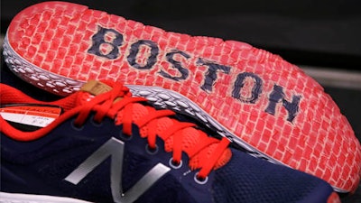 In this Wednesday, Dec. 28, 2016 photograph, the word 'Boston' accents the sole of the New Balance Zante v2 shoe on display at the storefront of the world headquarters of New Balance in the Brighton neighborhood of Boston. Some of America's top sneaker makers are racing to the Boston area. Reebok picked the city's Seaport District for its new global headquarters in December. Homegrown Boston-area companies New Balance and Converse opened new offices in 2015. Industry watchers said the boldly designed headquarters are partly a bid to lure millennial talent.