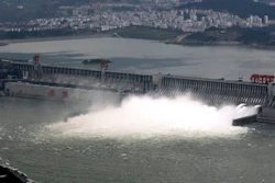 In this Nov. 7, 2008 photo, flow of water is discharged through the Three Gorges Dam in Yichang in central China's Hubei province. State-owned China Three Gorges Group is spending heavily to buy or build hydro, wind and solar projects at a time when Western utility investors are pulling back and U.S. President-elect Donald Trump’s pledge to revive coal use has raised doubt about U.S. support for renewables.