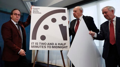 From left, Lawrence Krauss, theoretical physicist, chair of the Bulletin of the Atomic Scientists Board of Sponsors; Thomas Pickering, co-chair of the International Crisis Group; and David Titley, a nationally known expert in the field of climate, the Arctic, and national security, unveil the Doomsday Clock during a news conference at the National Press Club in Washington, Thursday, Jan. 26, 2017, announcing that the Bulletin of the Atomic Scientist have moved the minute hand of the Doomsday Clock to two and a half minutes to midnight.