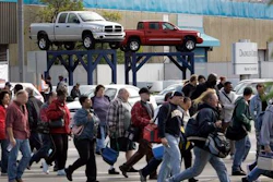 In an Oct. 24, 2007 file photo, workers leave the Warren Truck Assembly, a Chrysler automobile factory, during a shift change in Warren, Mich. Fiat Chrysler said Sunday, Jan. 8. 2017, it will add three new Jeeps to its lineup including a pickup truck as it invests $1 billion in two U.S. factories and creates 2,000 new jobs.