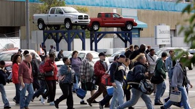 In an Oct. 24, 2007 file photo, workers leave the Warren Truck Assembly, a Chrysler automobile factory, during a shift change in Warren, Mich. Fiat Chrysler said Sunday, Jan. 8. 2017, it will add three new Jeeps to its lineup including a pickup truck as it invests $1 billion in two U.S. factories and creates 2,000 new jobs.