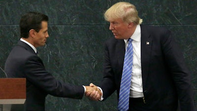 In this Aug. 31, 2016 file photo, Mexico's President Enrique Pena Nieto, left, and Republican presidential nominee Donald Trump shake hands after a joint statement at Los Pinos, the presidential official residence, in Mexico City. Before his swearing-in, Trump has already hurt Mexico's economy by pressuring automakers to shift factories out of Mexico and amid an uncertain economic outlook, the peso has plunged to all-time lows against the U.S. dollar.