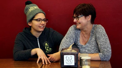 In this Jan. 9, 2017, photo, Andrea Ledesma, left, talks with her mother, Cheryl Romanowski, at Classic Slice pizza restaurant, where Ledesma works, in Milwaukee.