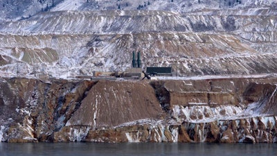 In this Dec. 14, 2016, photo the Horseshoe Bend Treatment Plant is seen at the far shore of the Berkeley Pit in Butte, Mont. Federal officials plan to pump the toxic water into the plant starting in 2023 to keep it below a critical level and prevent it from escaping the pit.