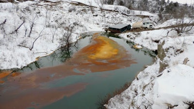 This Dec. 10, 2016, file photo, provided by the North Dakota Department of Health shows an oil spill from the Belle Fourche Pipeline that was discovered Dec. 5, 2016 in Ash Coulee Creek, a tributary of the Little Missouri River, near Belfield, N.D. President Barack Obama's administration has scaled back new safety measures for the sprawling network of fuel pipelines that crisscross the United States after complaints from industry over the potential cost.
