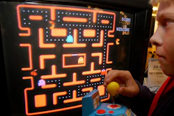 In this Oct. 5, 2004, file photo, Jake Gautney, 12, of Chappaqua, N.Y., tries a Ms. Pac-Man game at the Toy Industry Association holiday preview in New York. Masaya Nakamura, the 'Father of Pac-Man' who founded the Japanese video game company behind the hit creature-gobbling game, died on Jan. 22, 2017. He was 91.